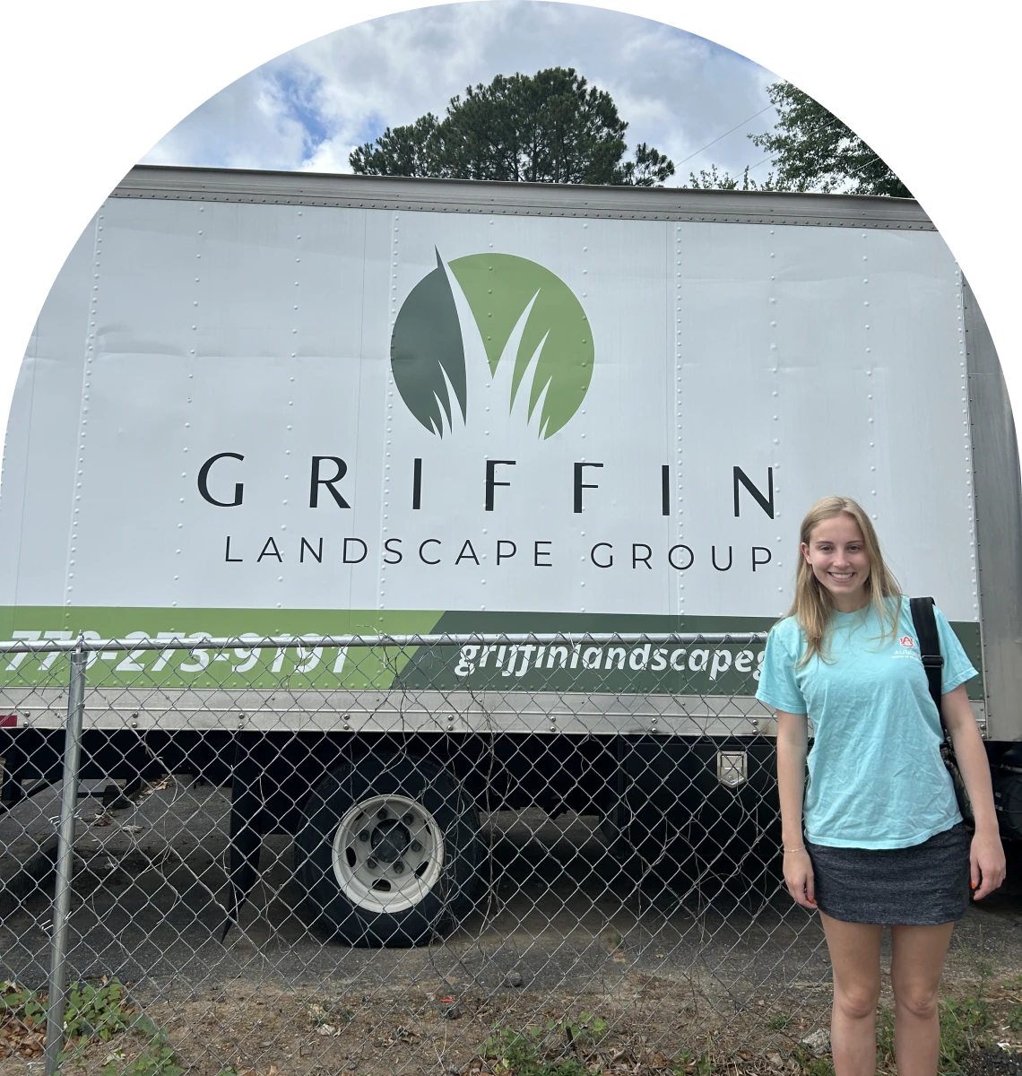 Woman posing near company truck